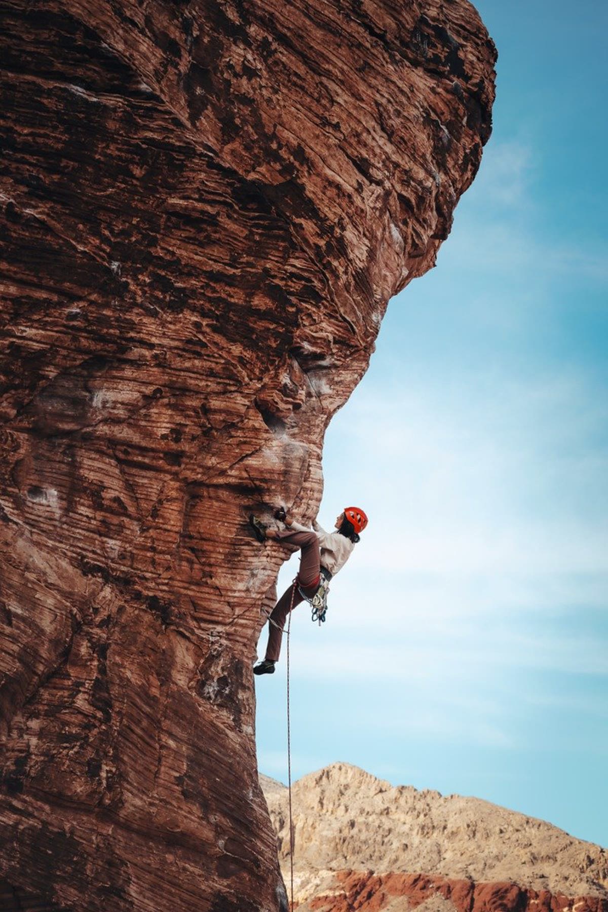 Kelly lead climbing on red sandstone